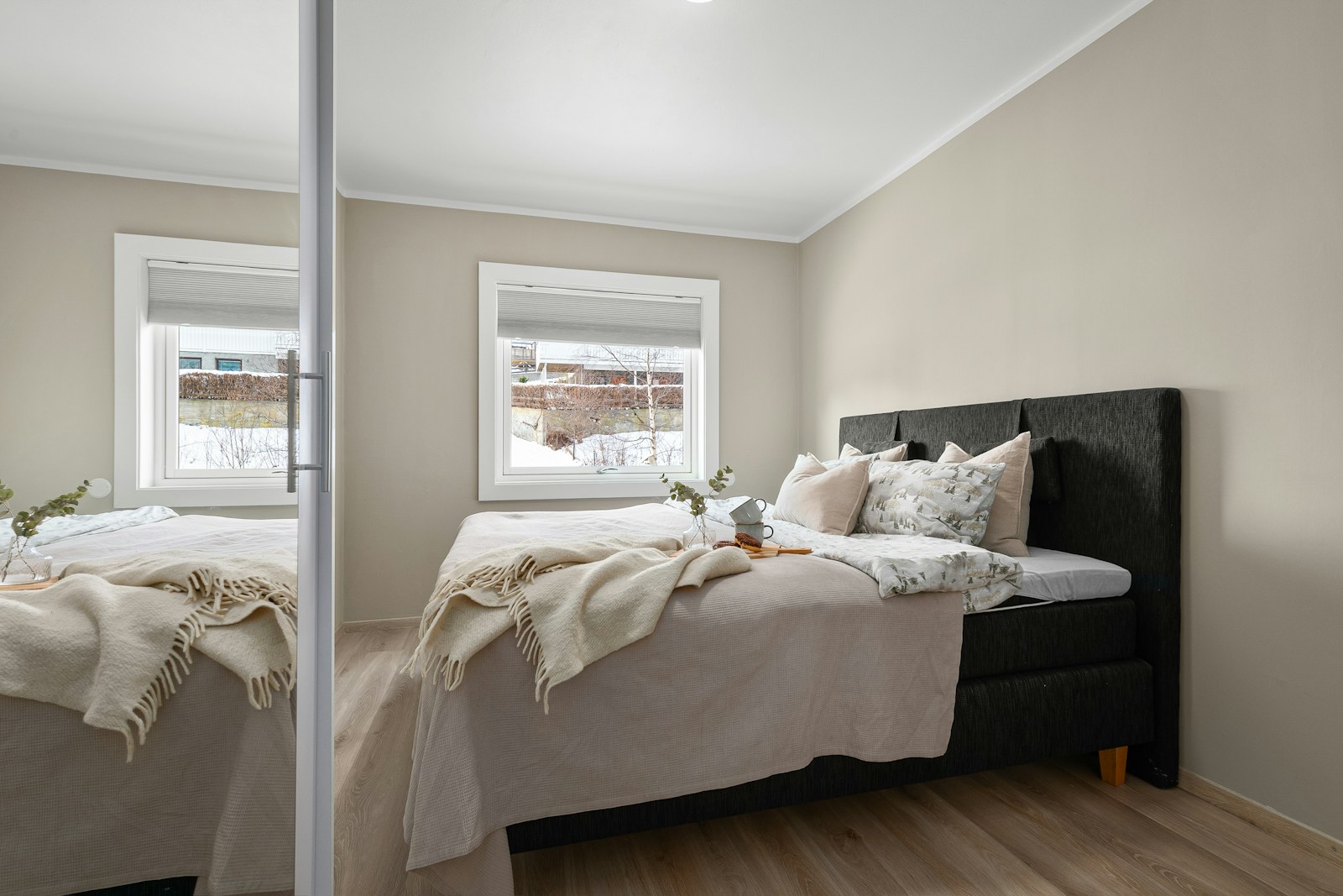 Contemporary bedroom with custom upholstered headboard and refined bed frame design