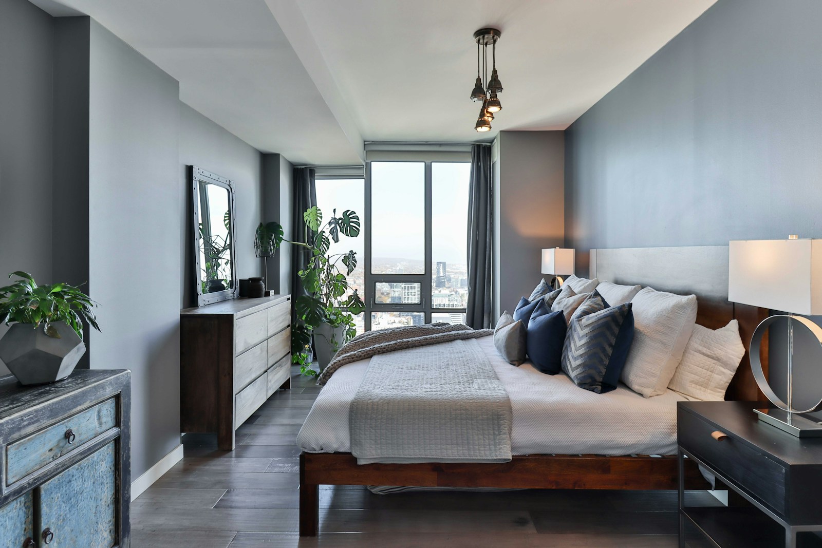 Custom luxury bed frame with dark wood construction and urban high-rise bedroom setting