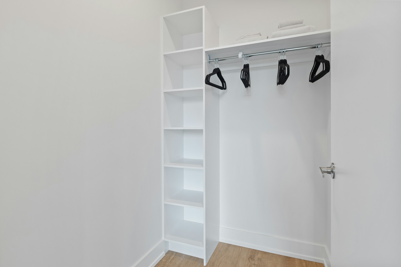 Built-in closet system with floor-to-ceiling shelving and premium wood finish