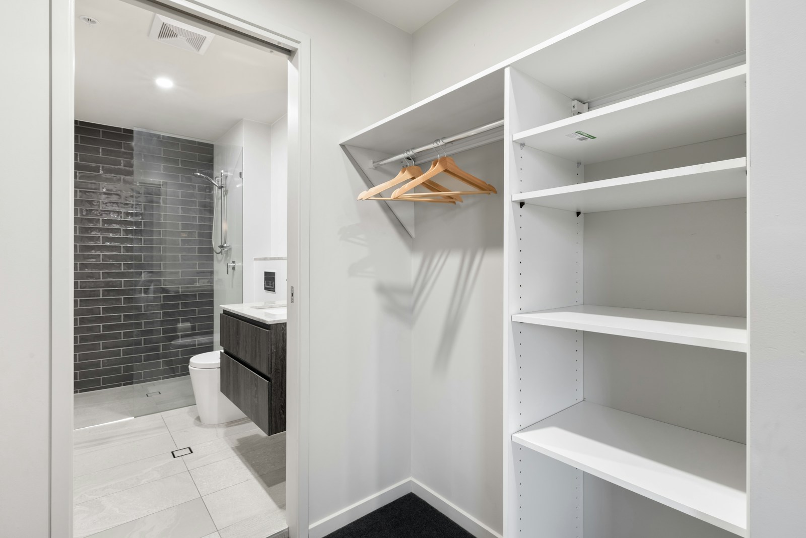 Custom closet cabinetry with integrated drawers, shelving, and hanging sections