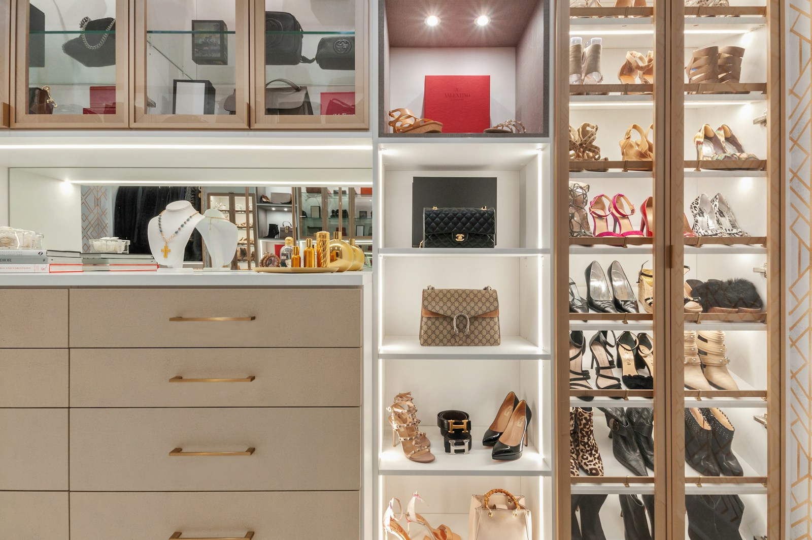 Luxury walk-in closet system with custom wood cabinetry and organized shoe display