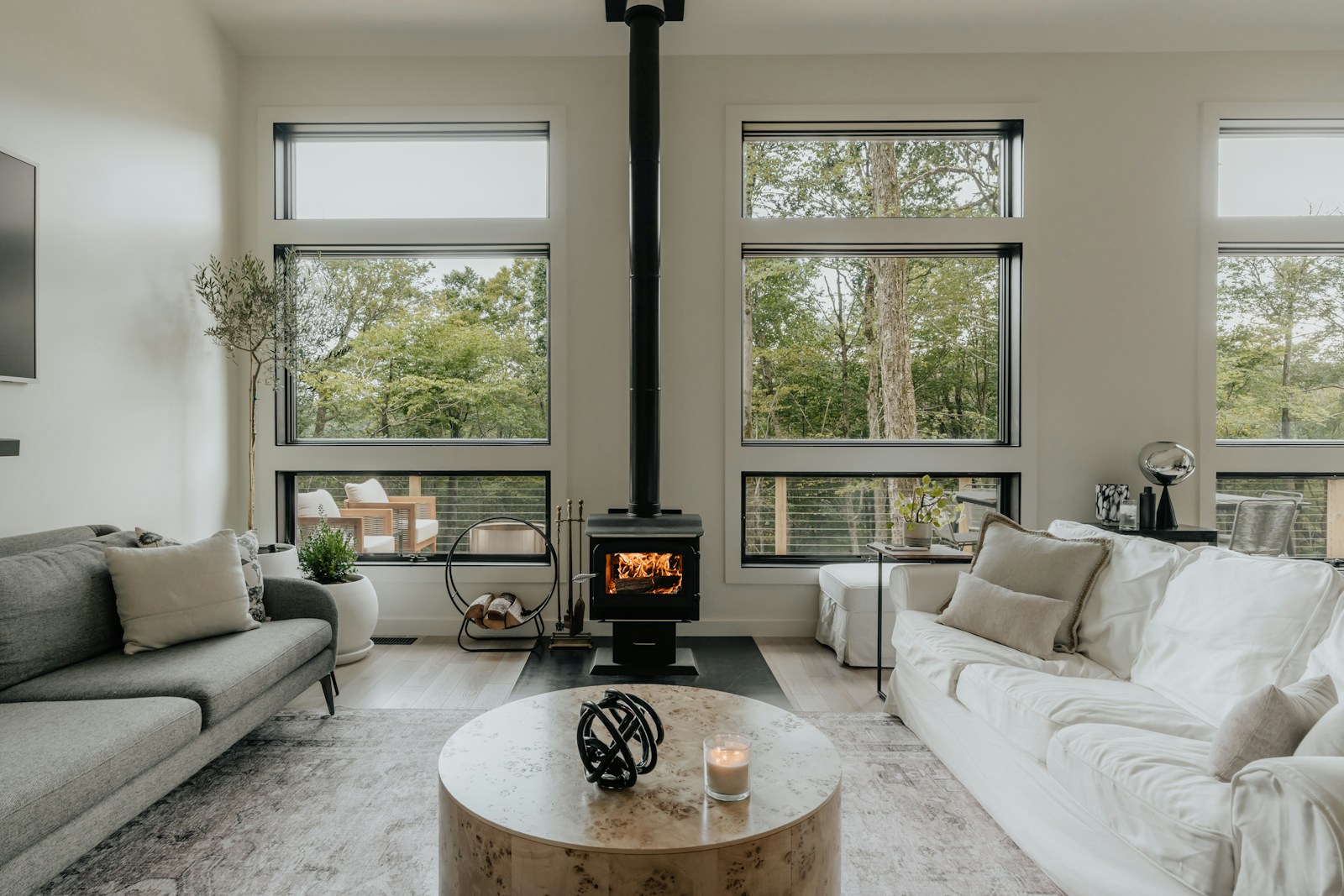 Scandinavian living room with custom round wood coffee table and cozy fireplace