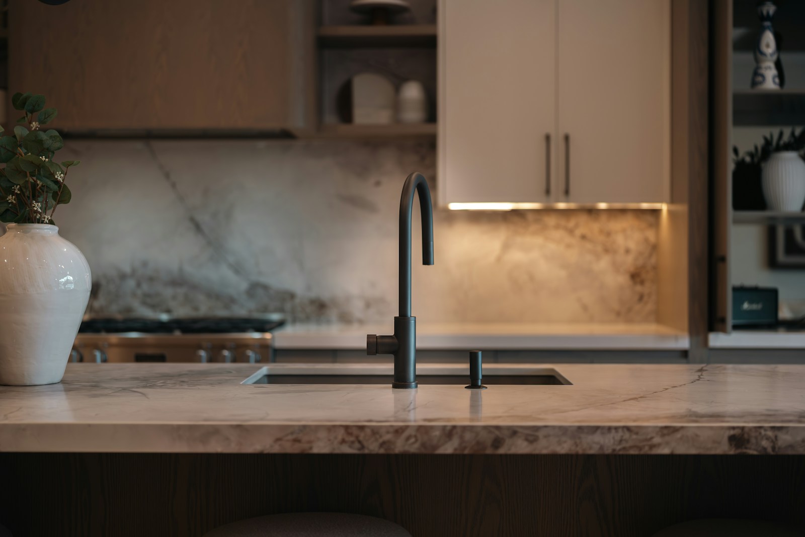 Contemporary kitchen with handleless flat-panel cabinets and large marble island