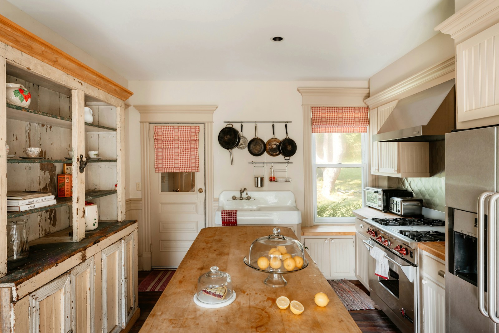 Dark cottage kitchen with painted cabinetry and warm wood accents