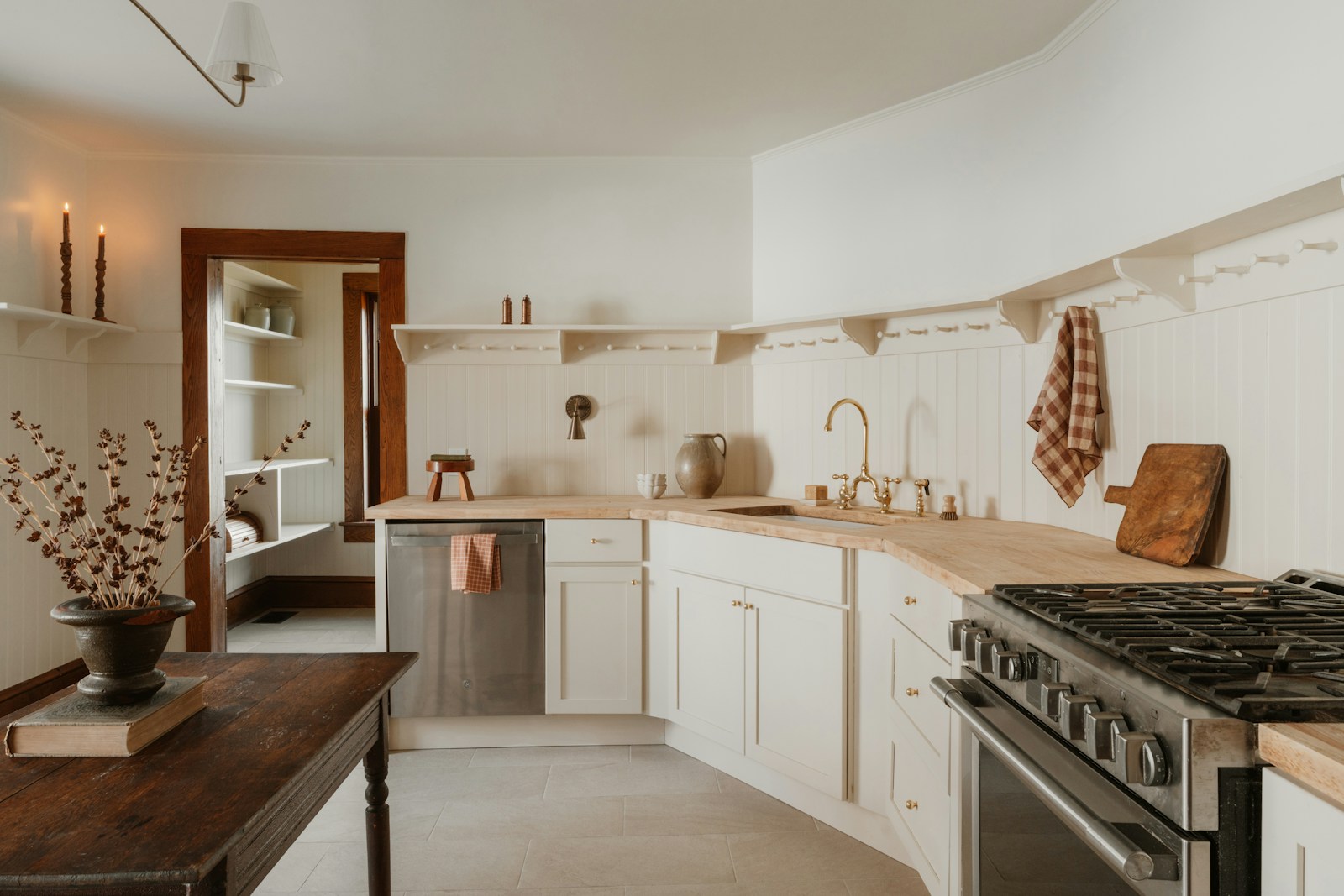 Cottage style white painted kitchen cabinets with farmhouse charm and natural light