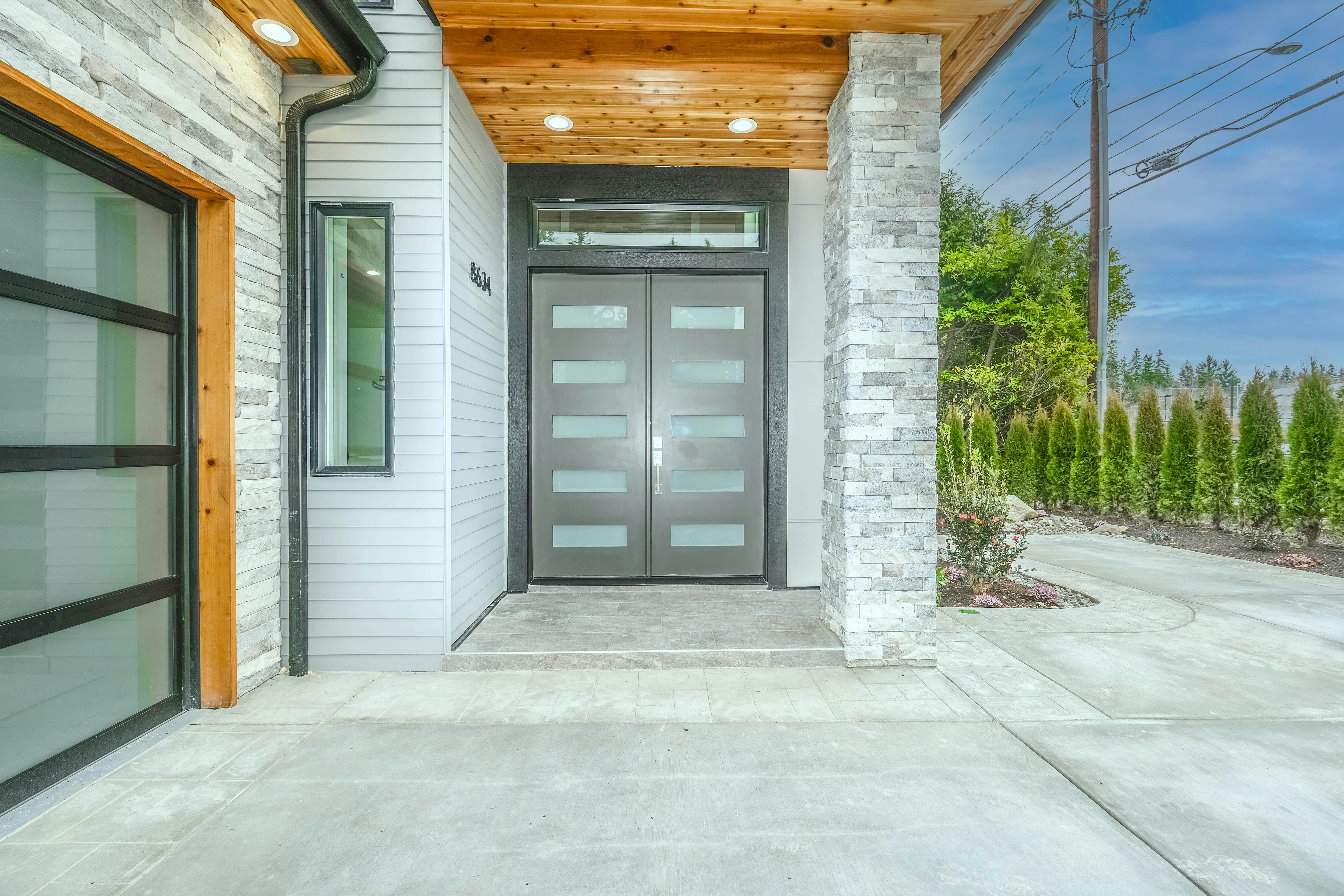 Custom double entry doors dark graphite glass panel inserts luxury modern home exterior