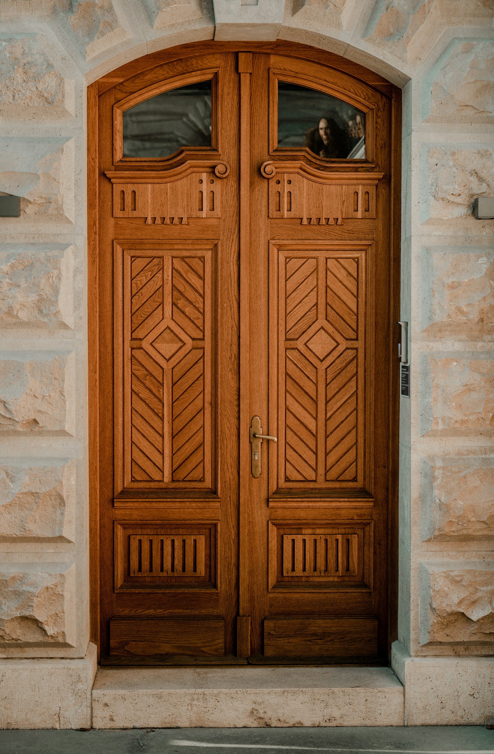 Grand custom entry door with sidelights and transom in luxury residential setting