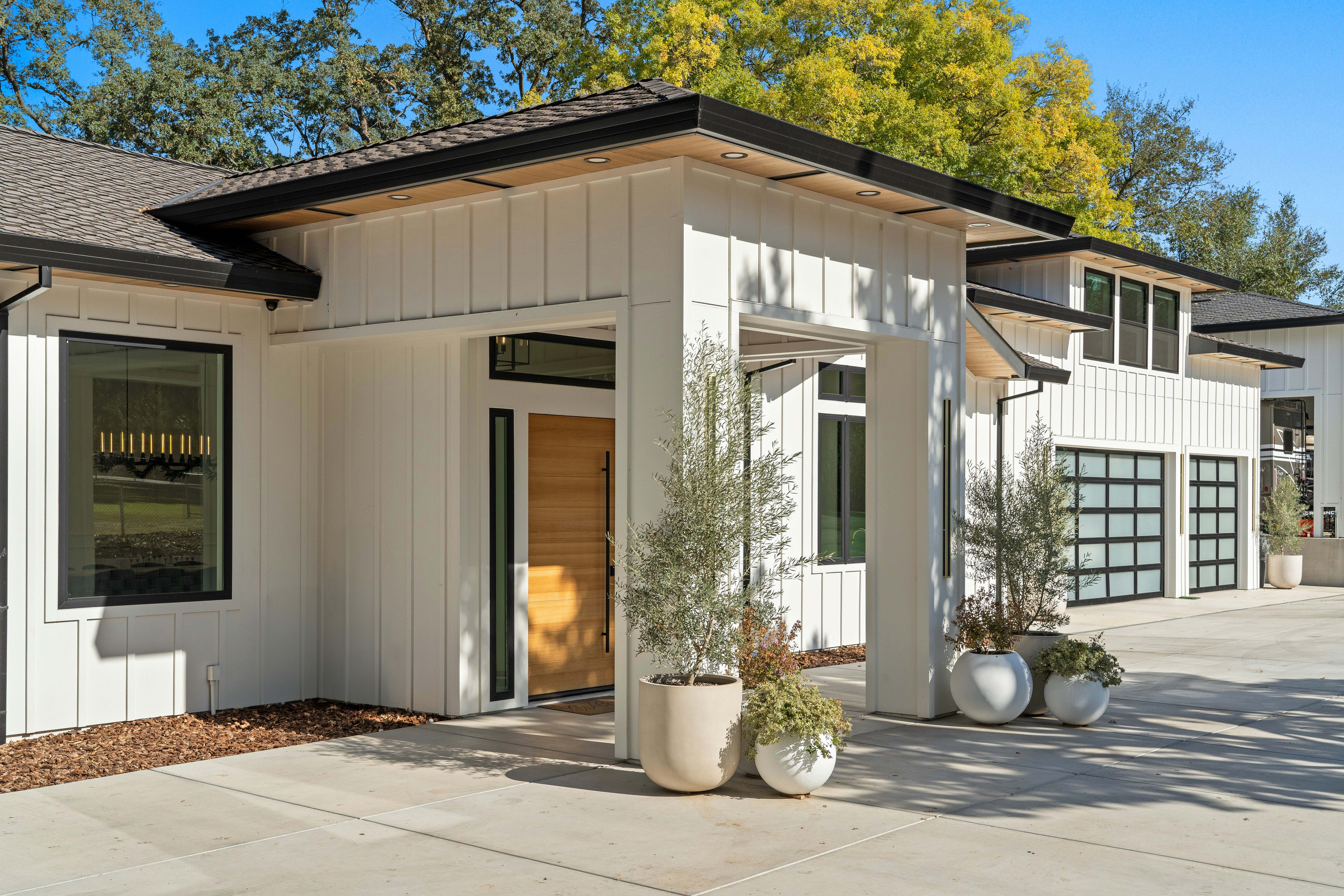 Custom premium natural wood front door modern farmhouse exterior olive trees refined