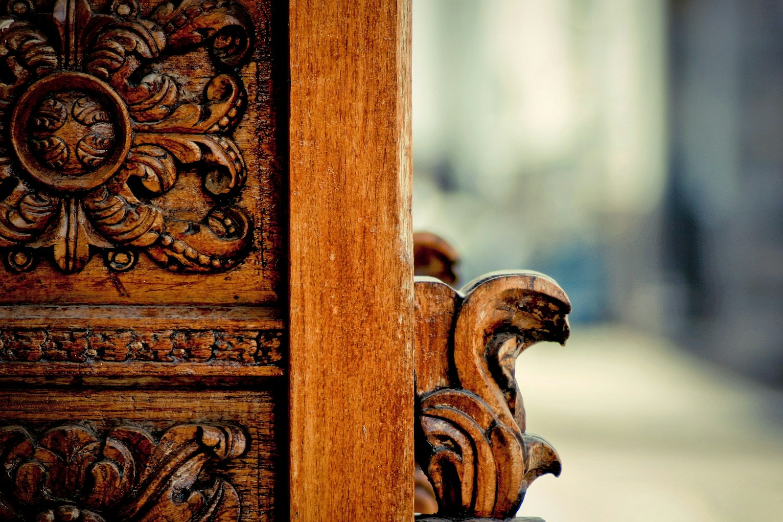Ornamental carved wood cabinet detail with intricate relief work and artisan craftsmanship