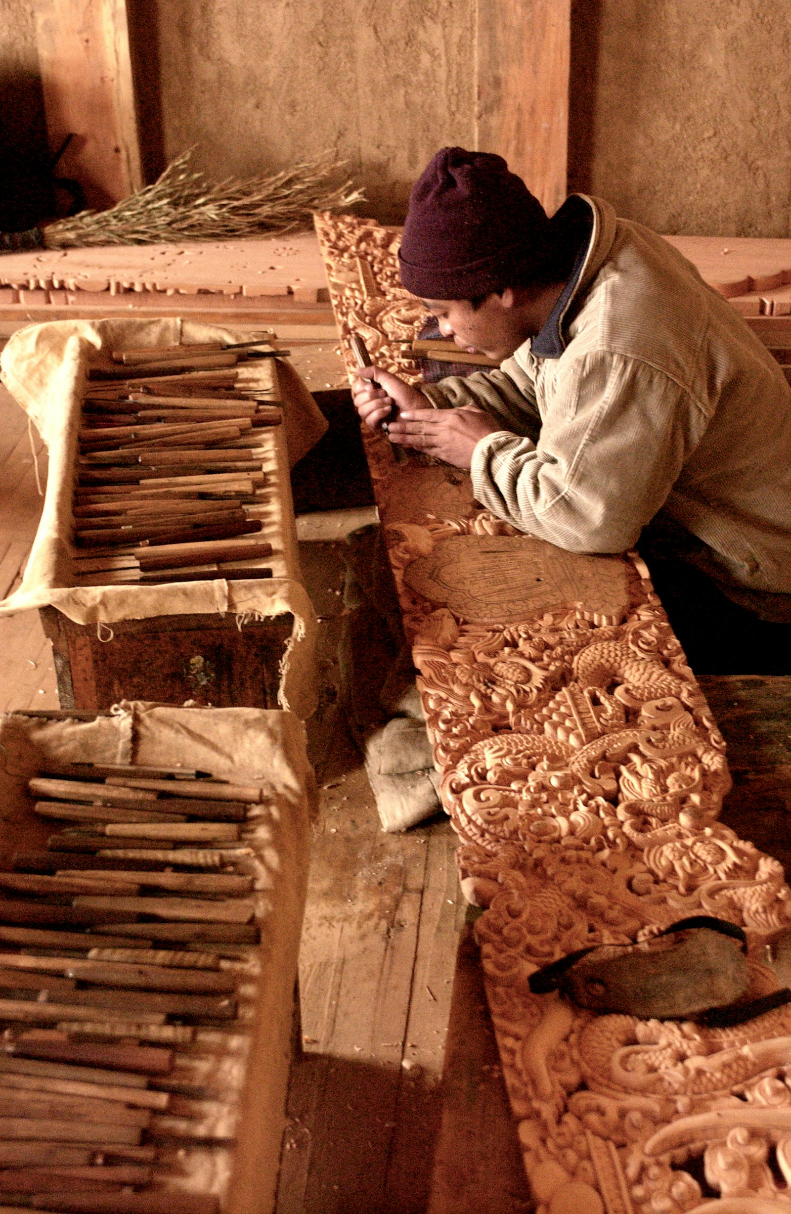 Intricate ornamental wood carving detail from artisan cabinet with traditional motifs