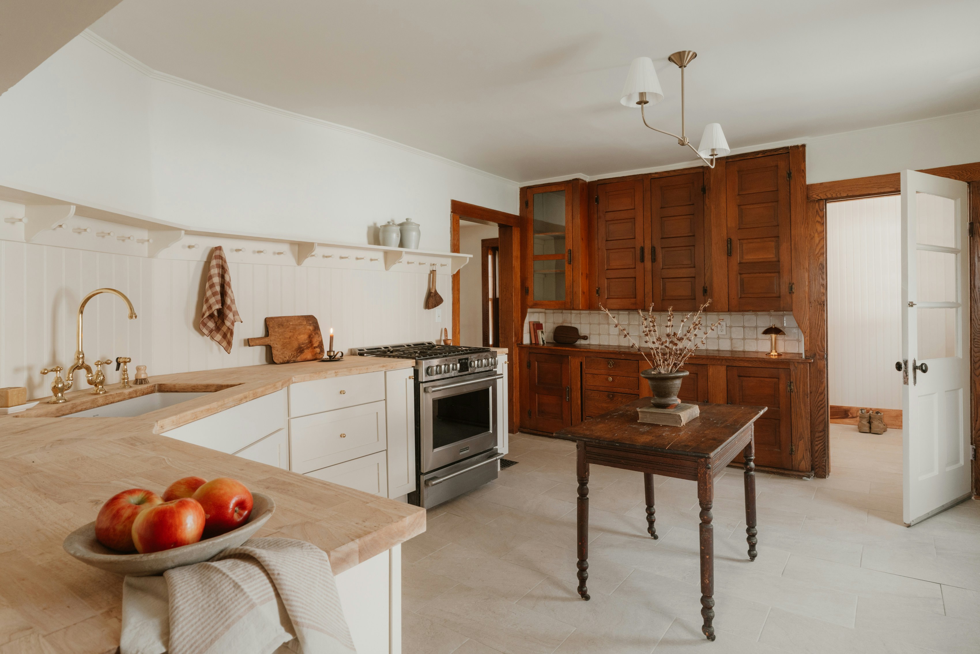 Rustic farmhouse kitchen natural walnut upper cabinets white lower cabinets butcher block