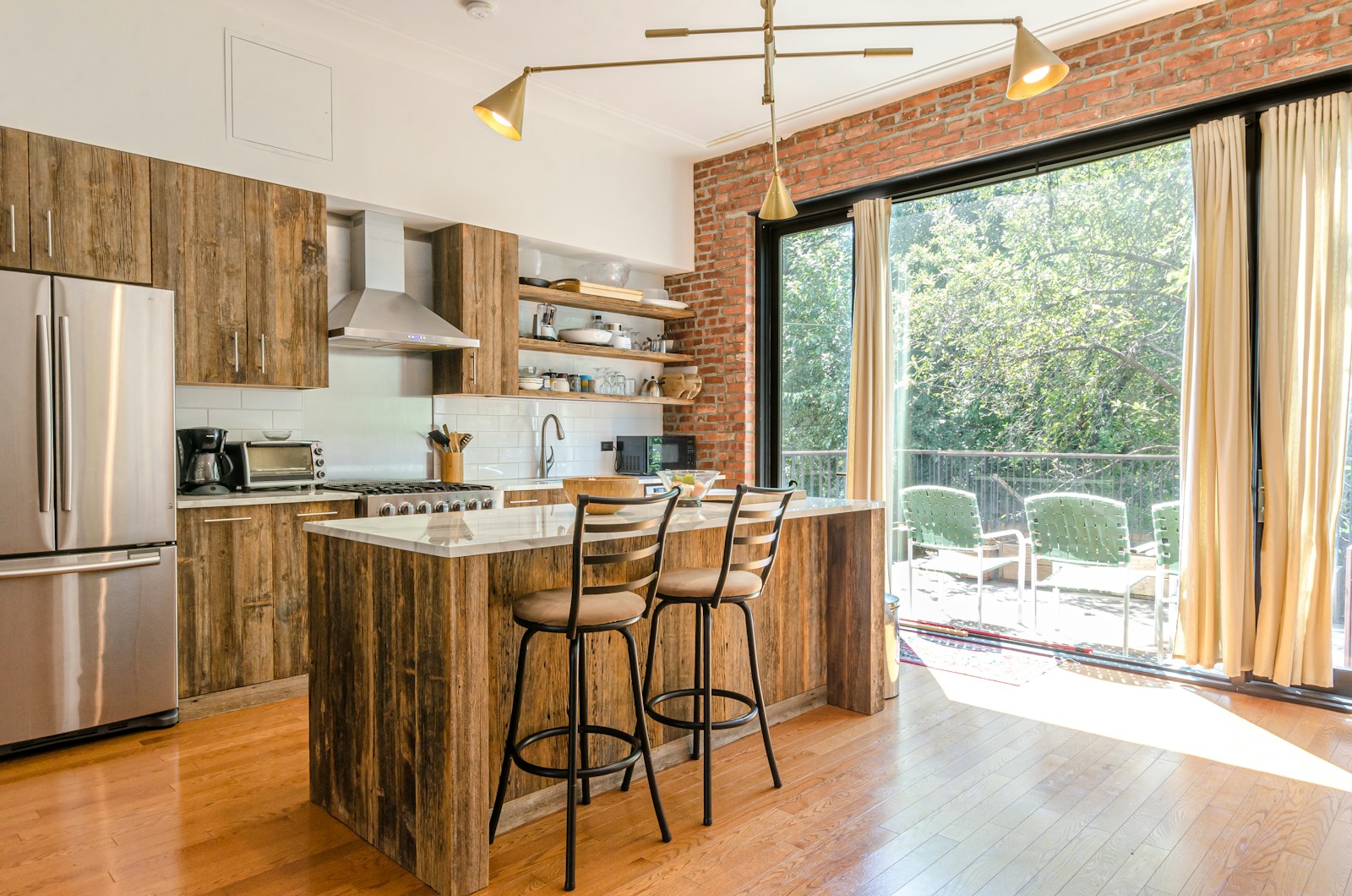 Rustic kitchen with reclaimed wood island and natural raw wood cabinetry