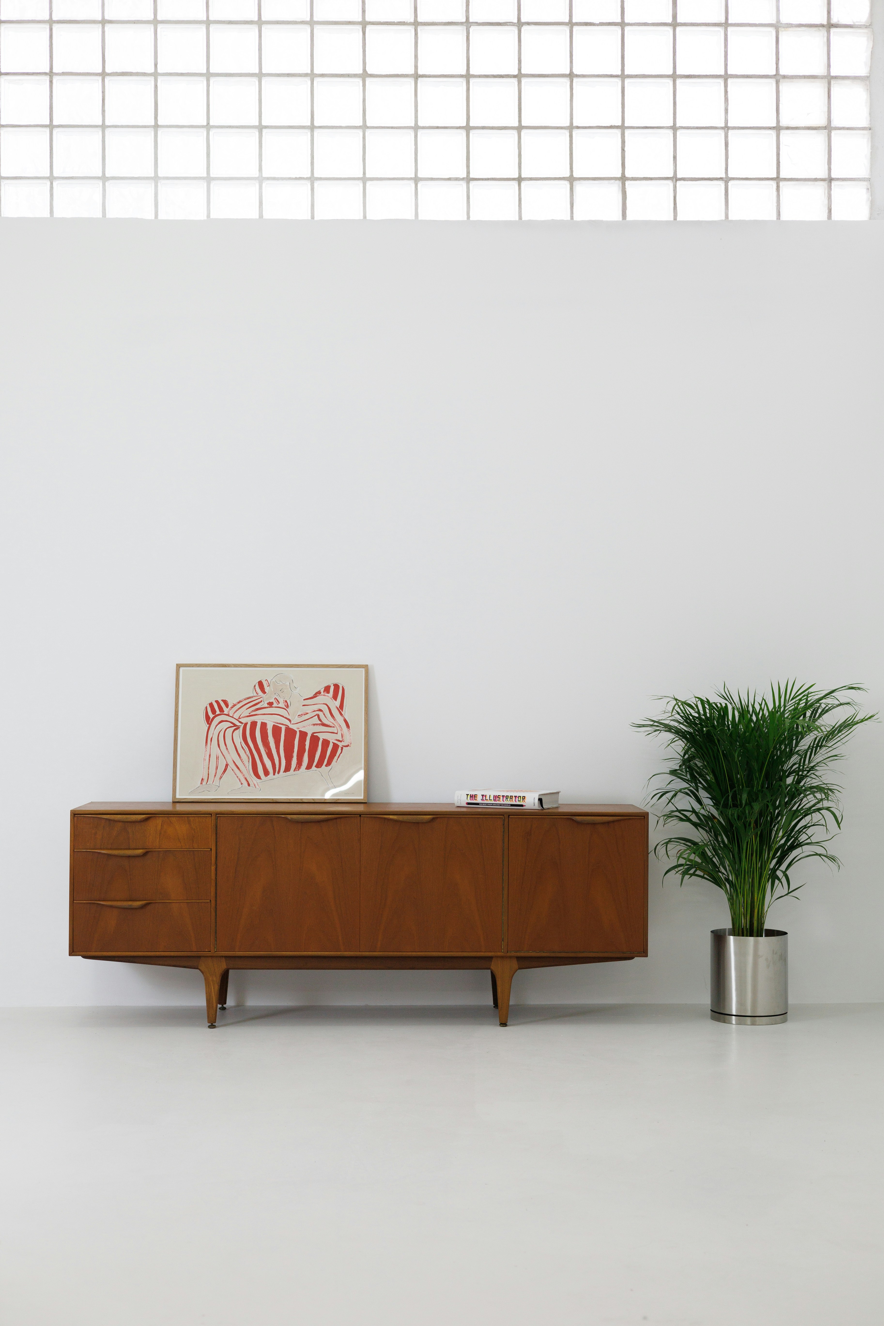 Mid-century modern teak sideboard sliding door panels brass handles warm interior