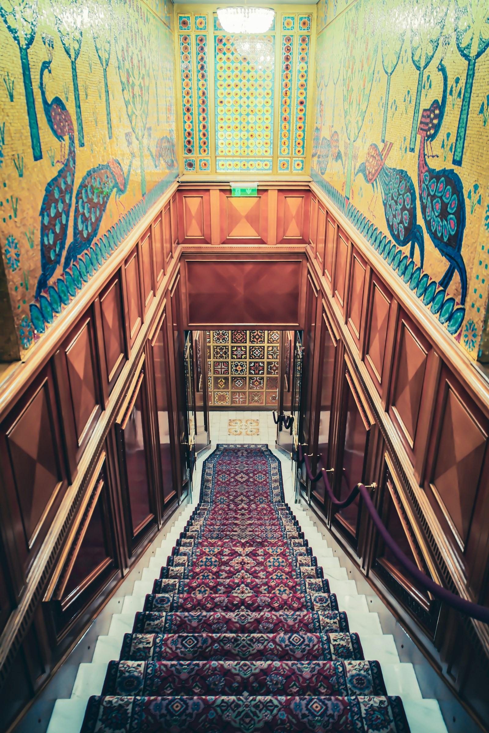 Grand custom staircase with ornate wood banister and premium hardwood treads
