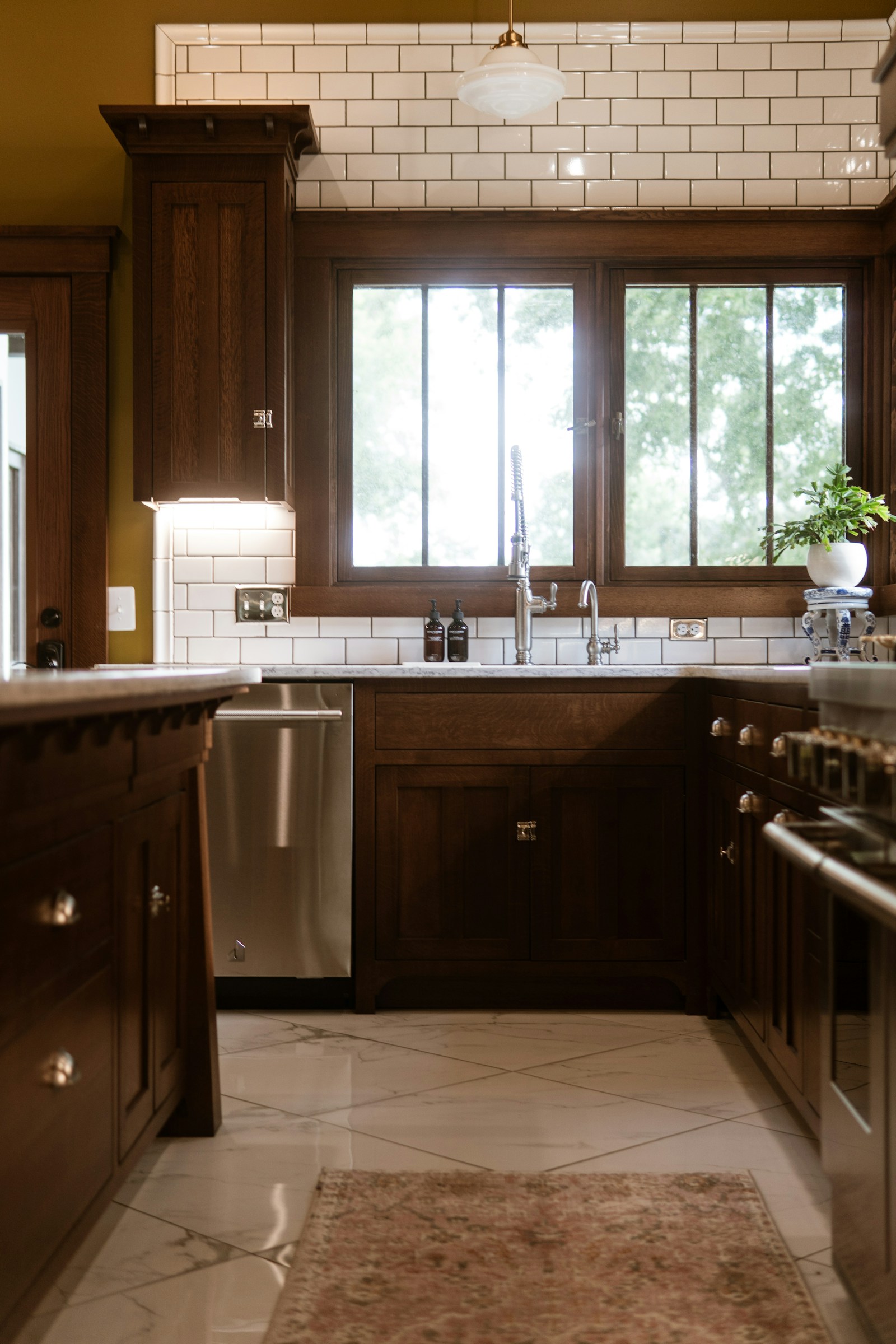 Traditional raised-panel kitchen cabinets in dark walnut with classic hardware