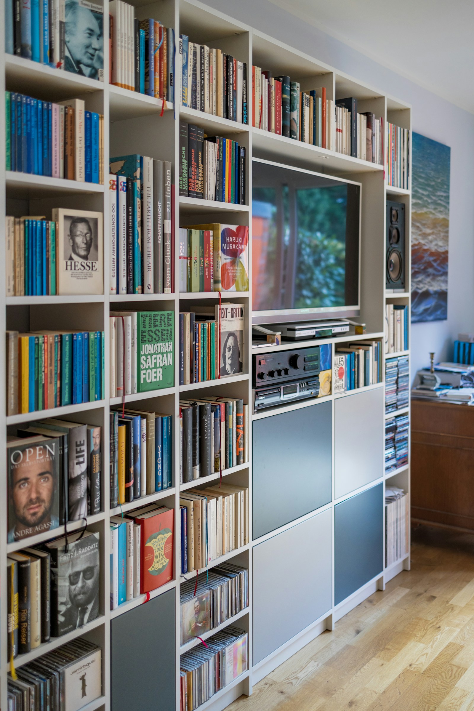 Custom library wall with built-in bookshelves and integrated TV media center
