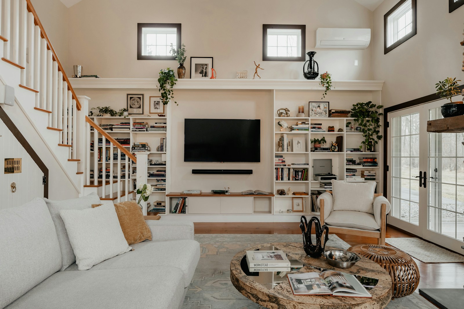 Custom built-in TV wall unit with floor-to-ceiling shelving and integrated cabinetry