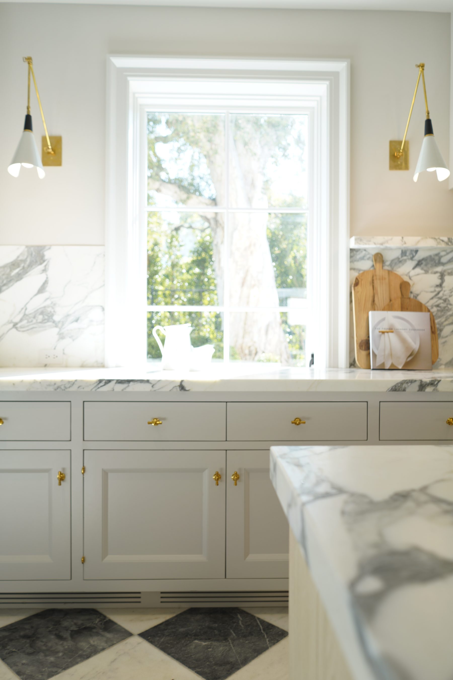 Custom white kitchen cabinet column brass hardware detail