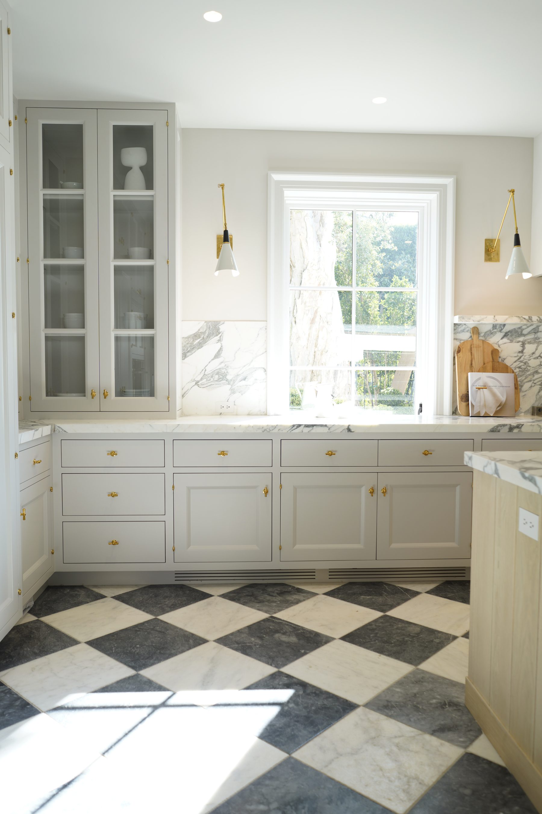 Custom white kitchen cabinetry installation with diamond floor