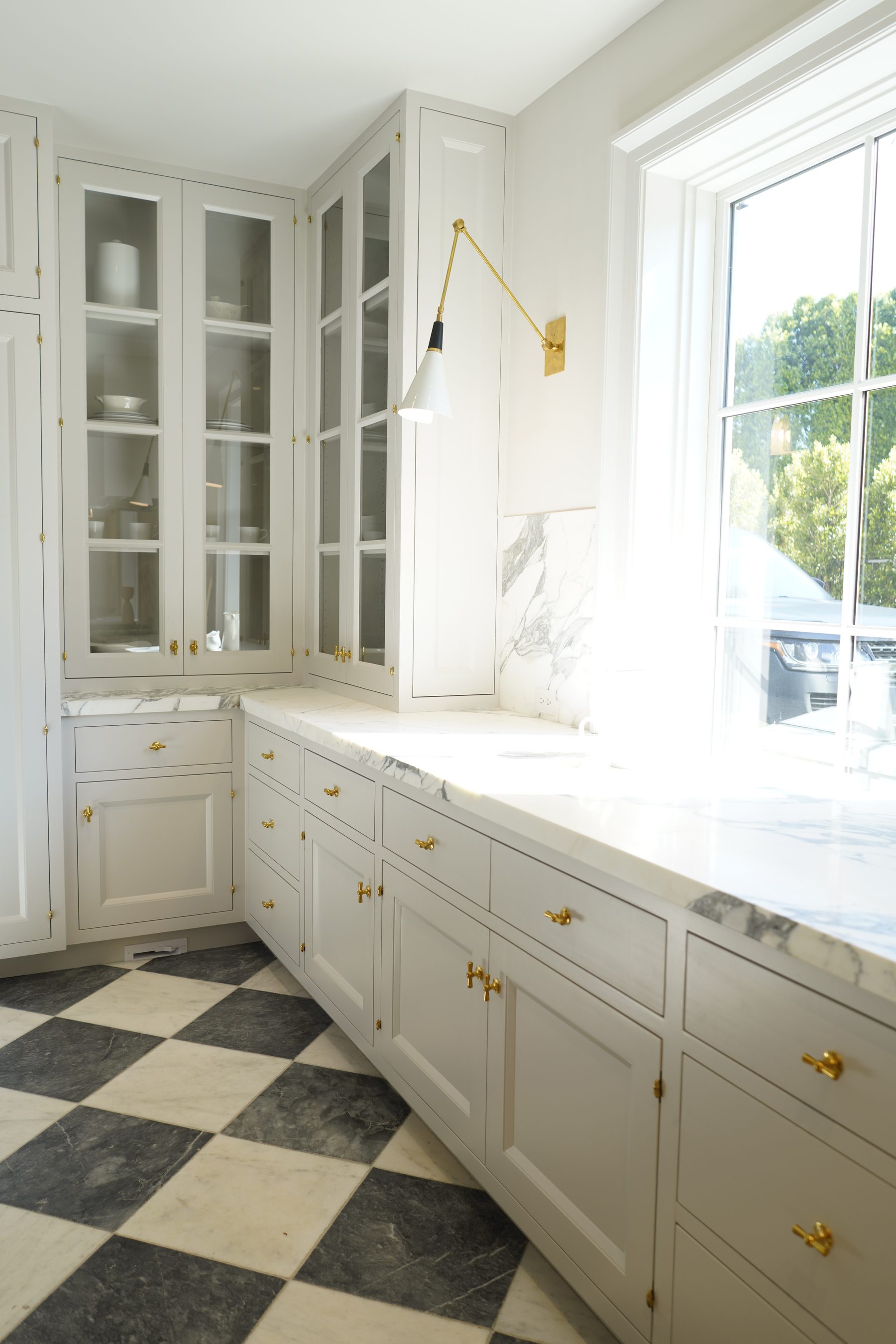 Custom white kitchen upper glass cabinet installation detail