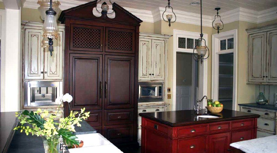 Cream distressed kitchen cabinetry red island walnut accents