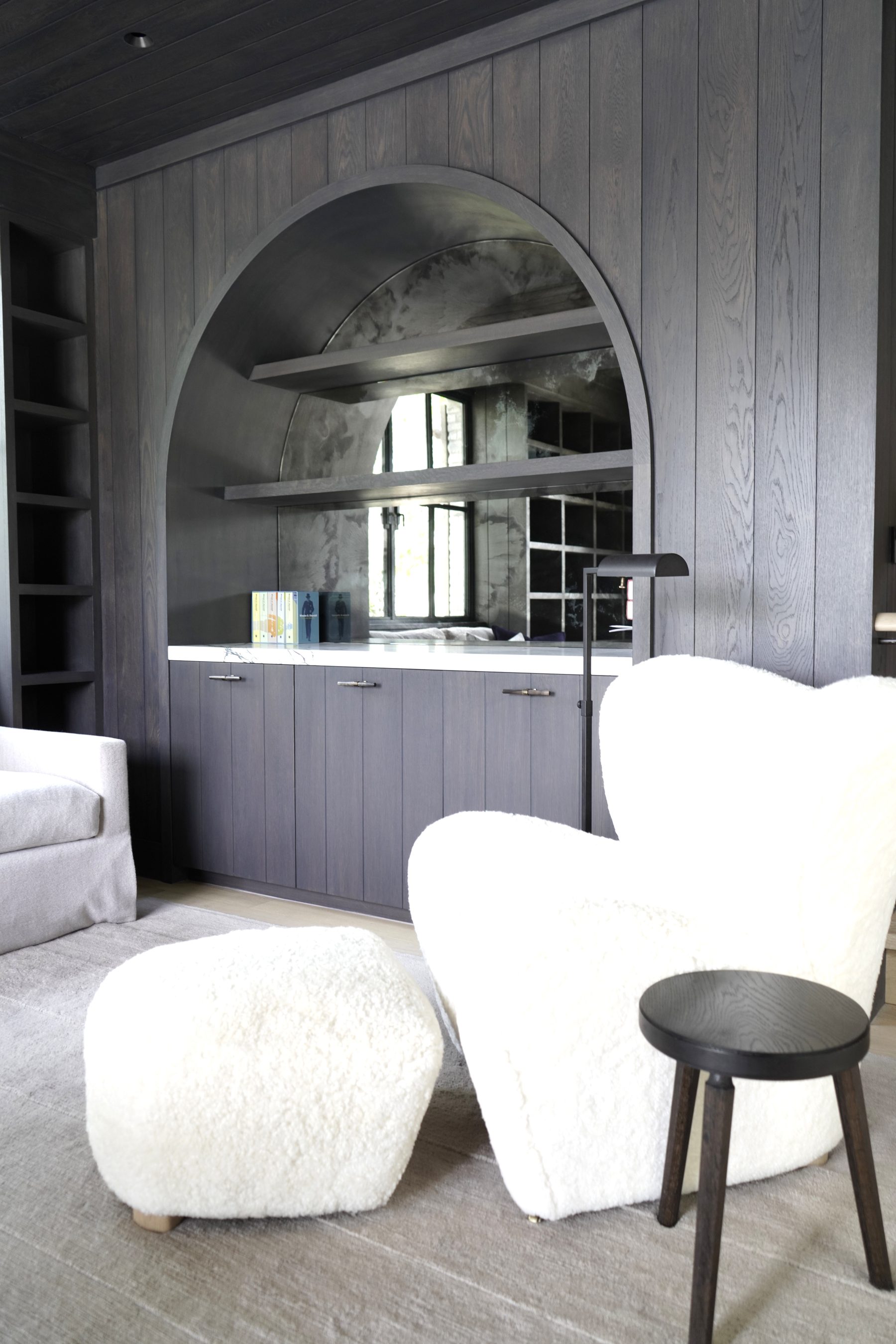 Custom gray wood panel door with circular mirror niche