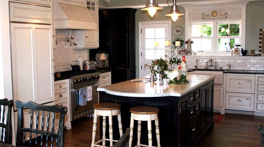 White painted kitchen cabinets with black island cottage style