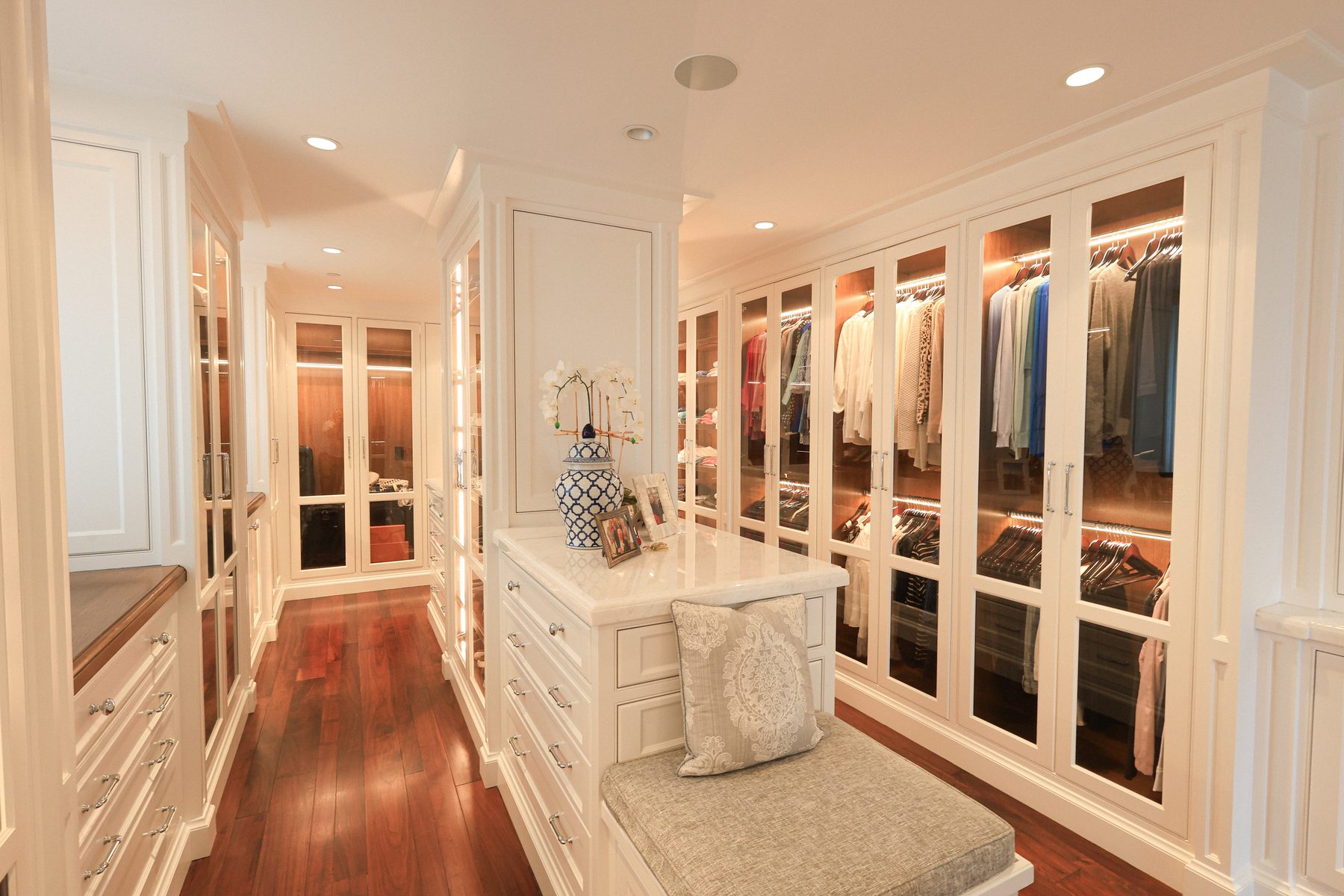 Custom white master closet glass-front built-in cabinetry Harbor Isle