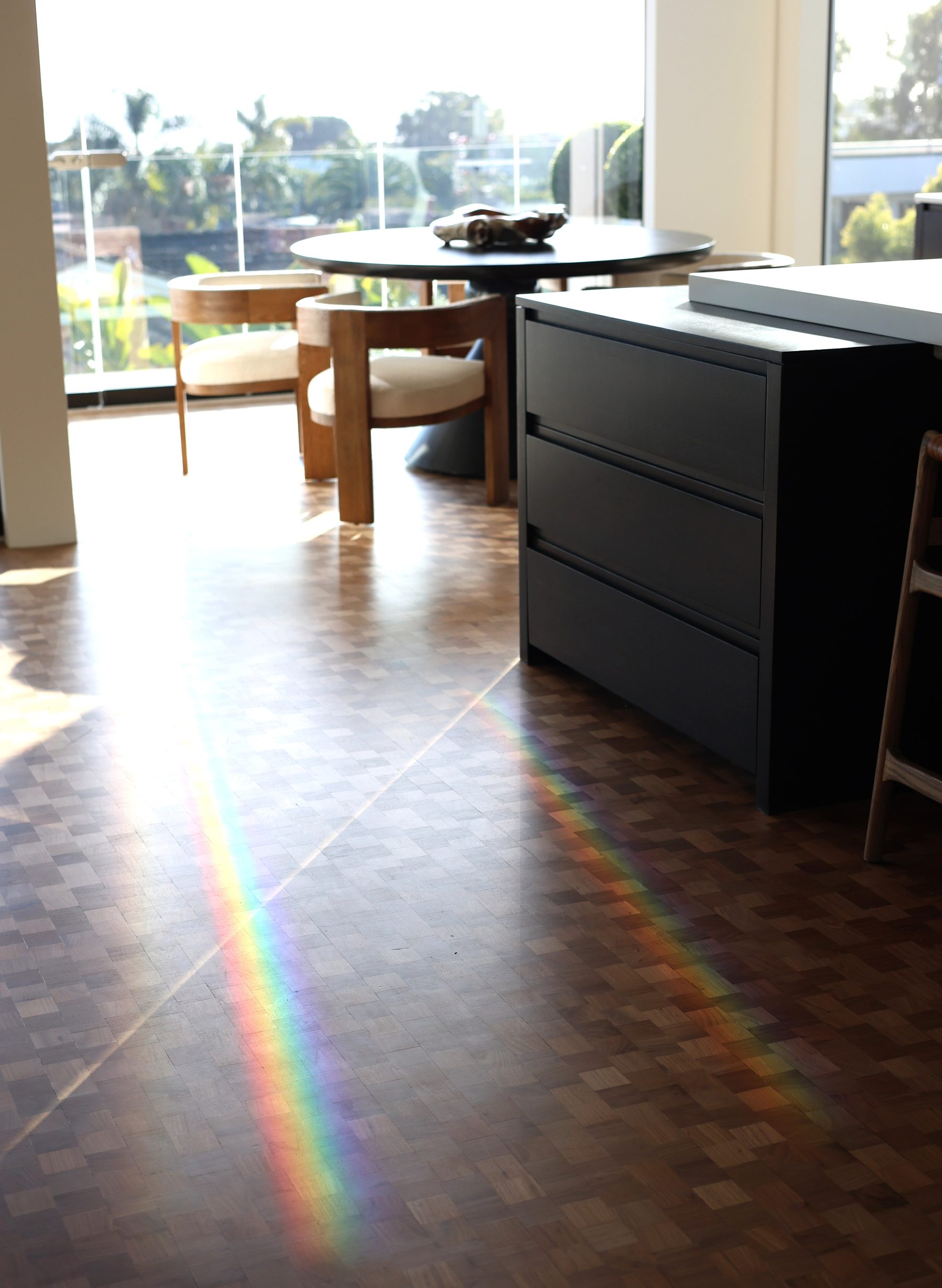 Modern dark kitchen island rainbow light herringbone floor