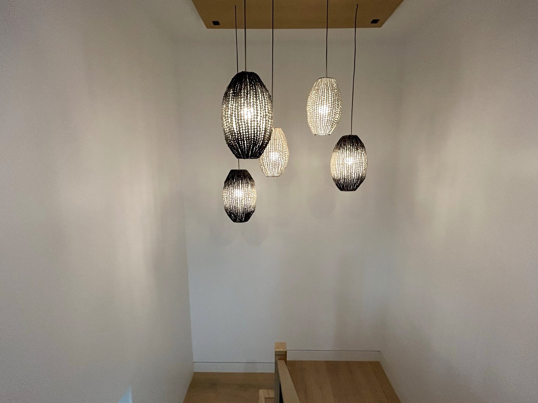 Modern home staircase pendant lights stairwell view