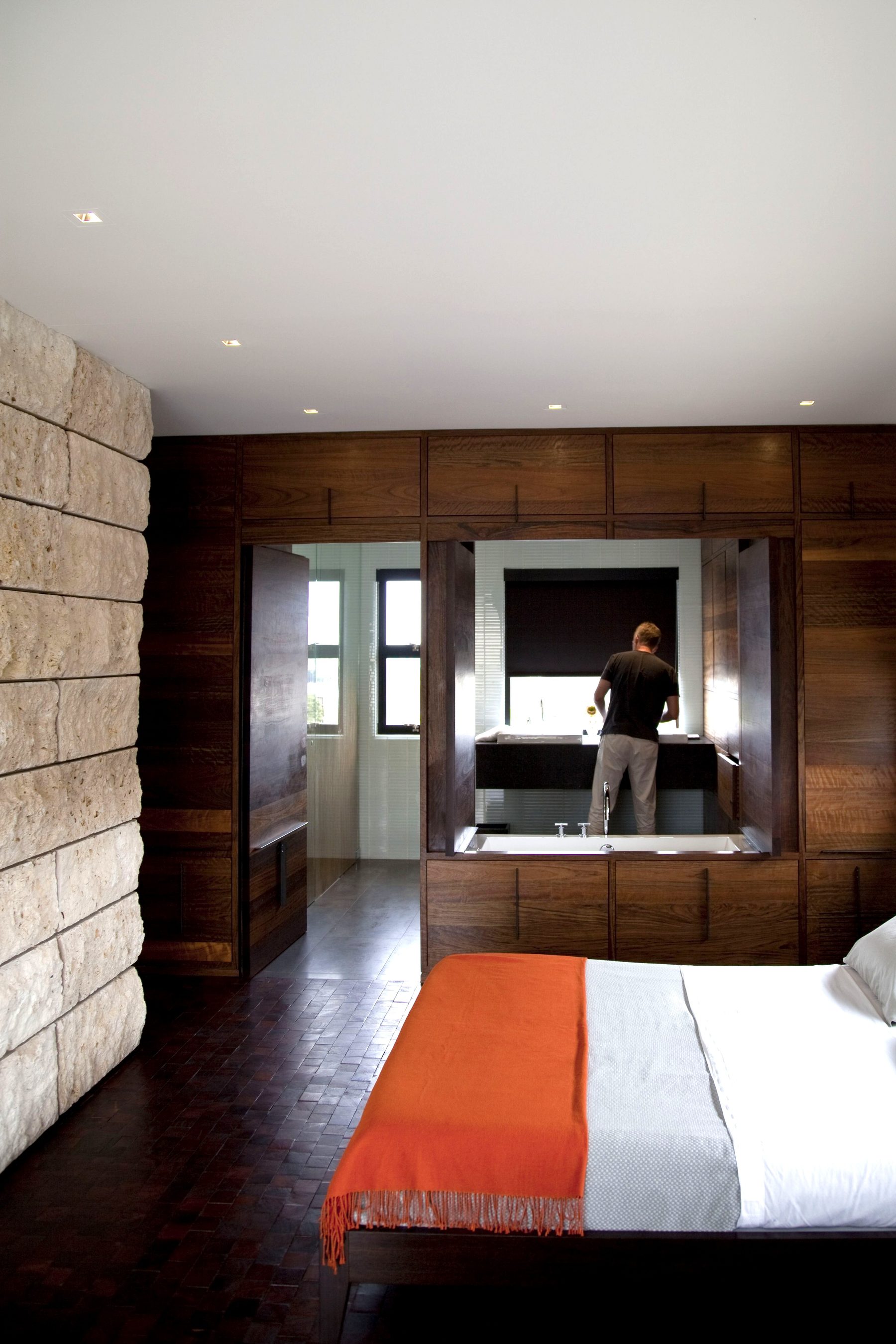 Custom walnut bedroom wall cabinetry soaking tub Newport Beach