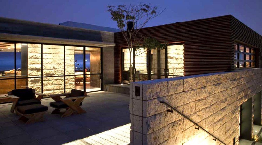 Newport Beach residence exterior stone wall wood slat night