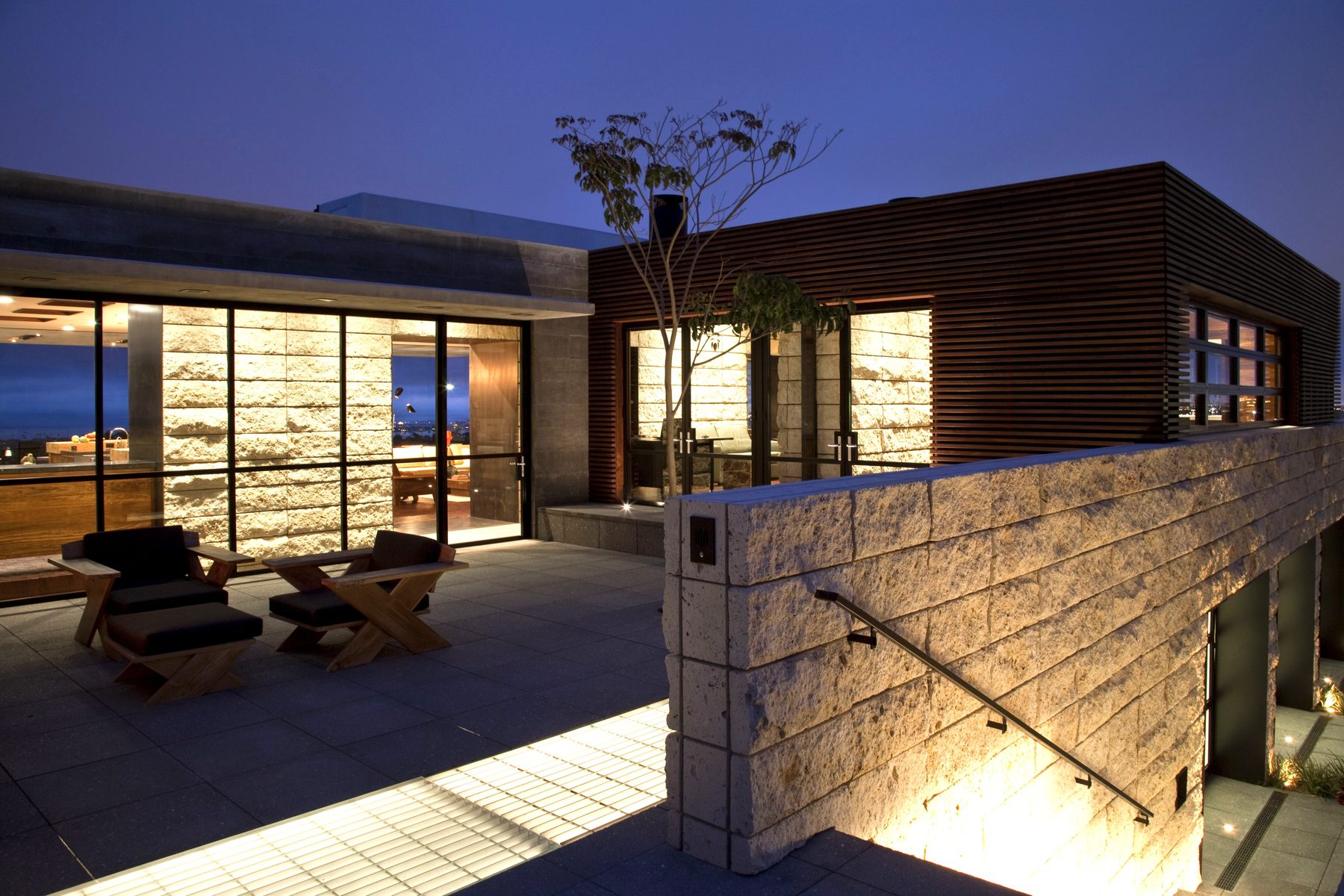 Newport Beach patio night wood slat stone seating