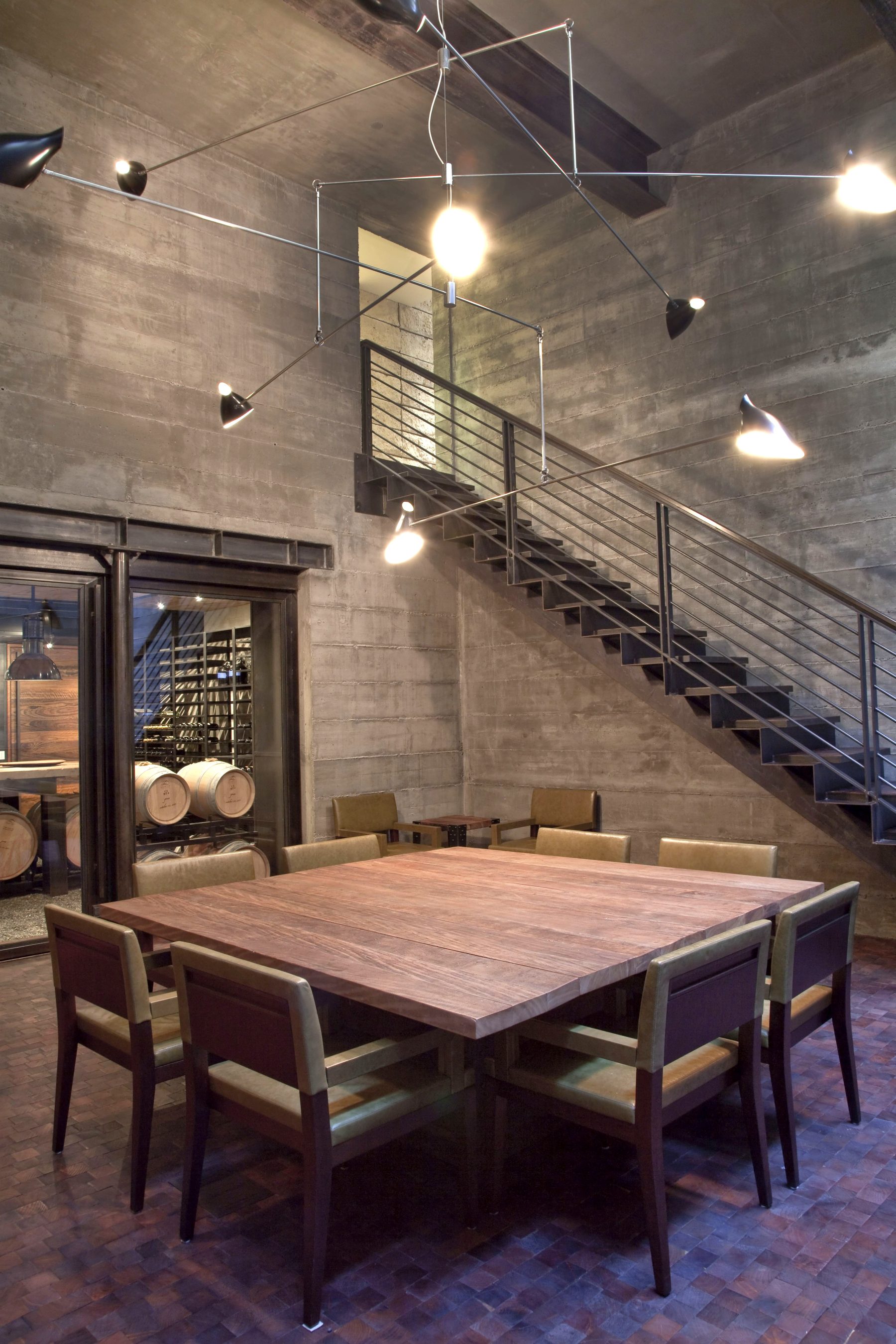 Custom wine cellar dining table concrete walls Newport Beach