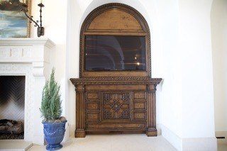 Custom carved entertainment cabinet built-in arched niche