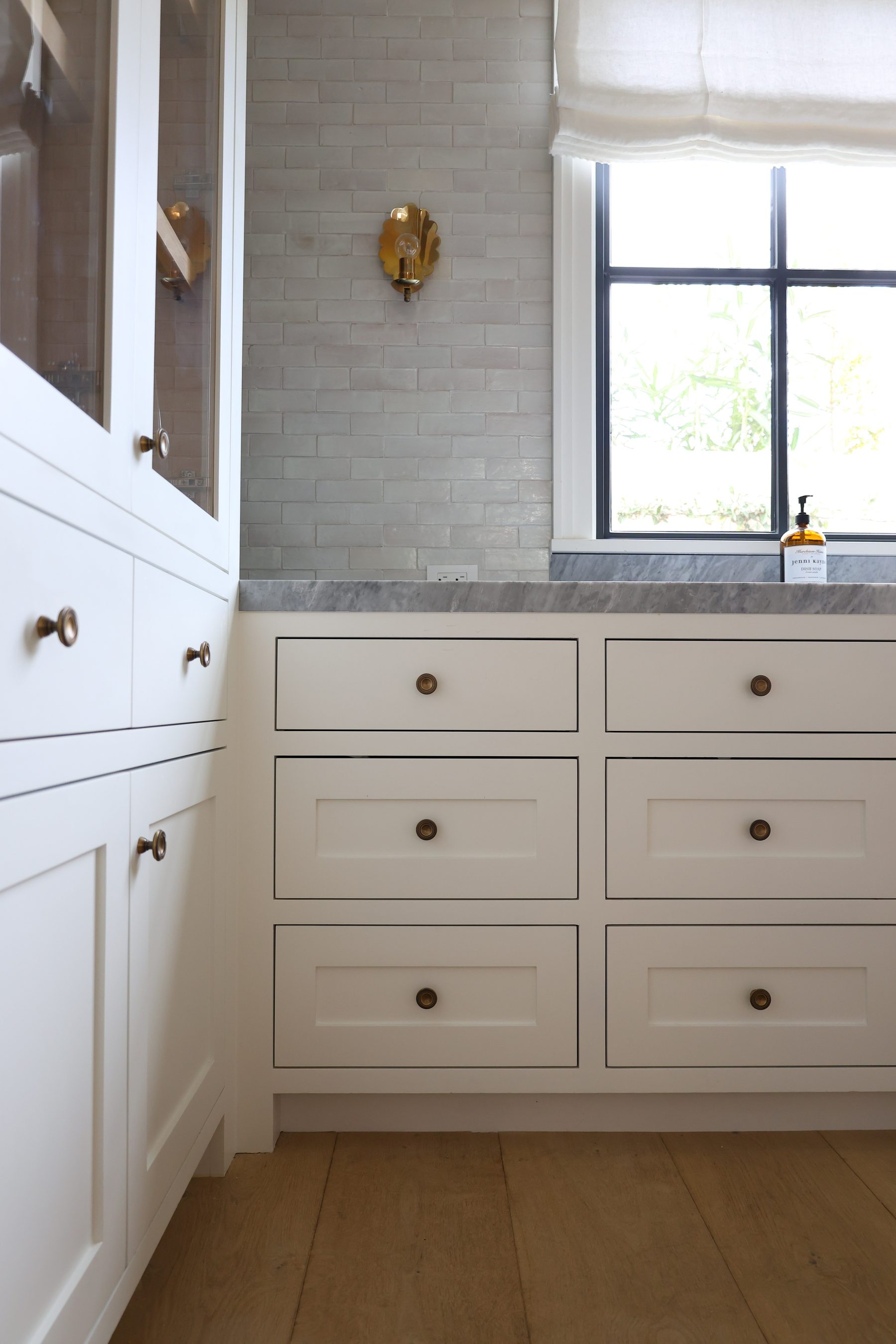 Custom white bathroom cabinet brass knobs zellige tile