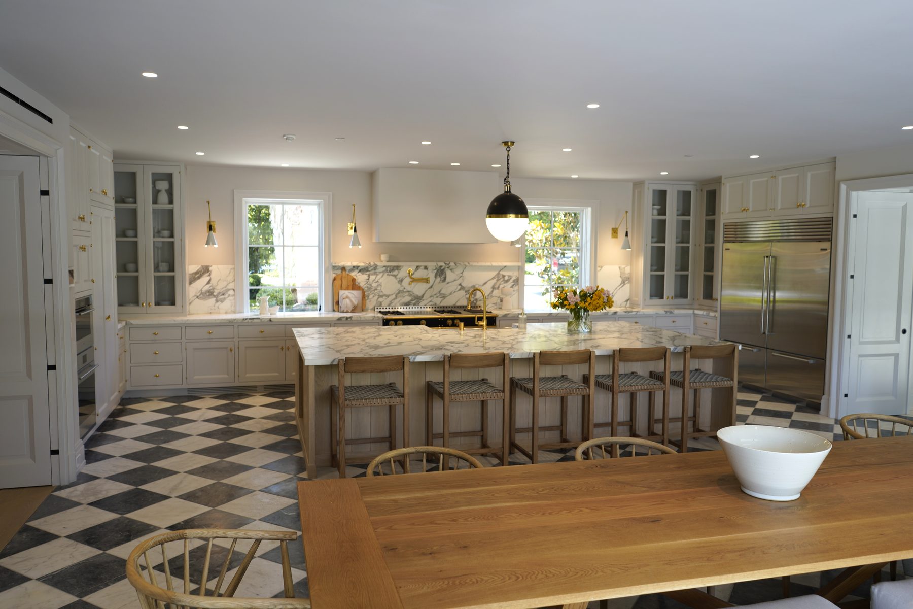 Custom white kitchen cabinetry diamond floor marble island glass cabinets
