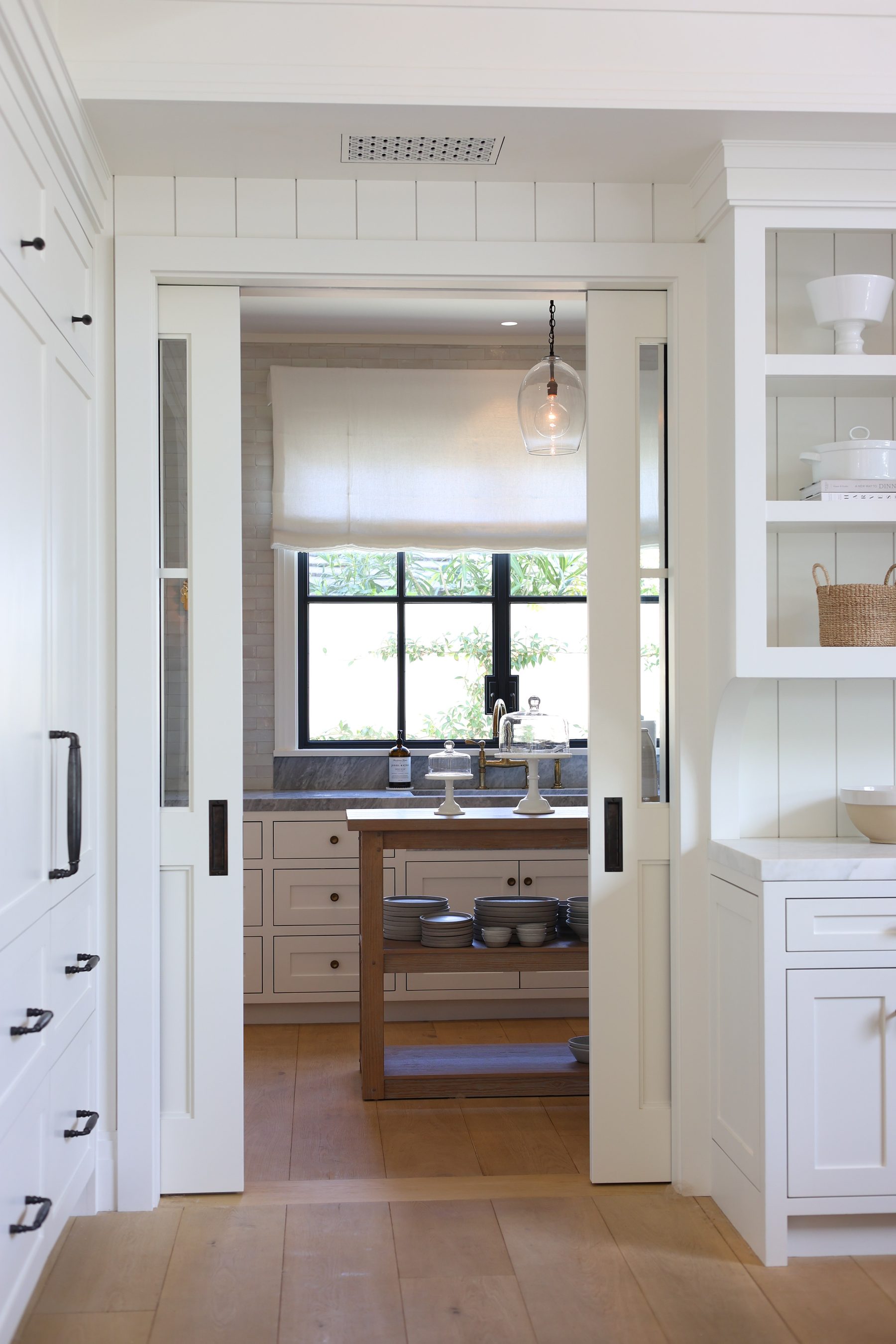 Custom white kitchen glass upper cabinets detail