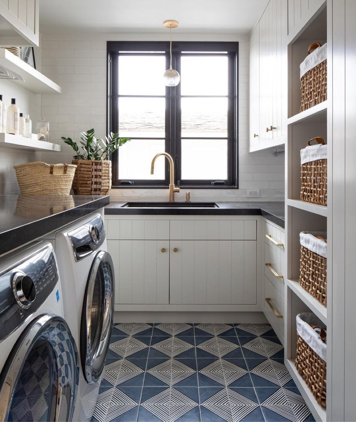 Custom white laundry room cabinetry open shelving brass hardware