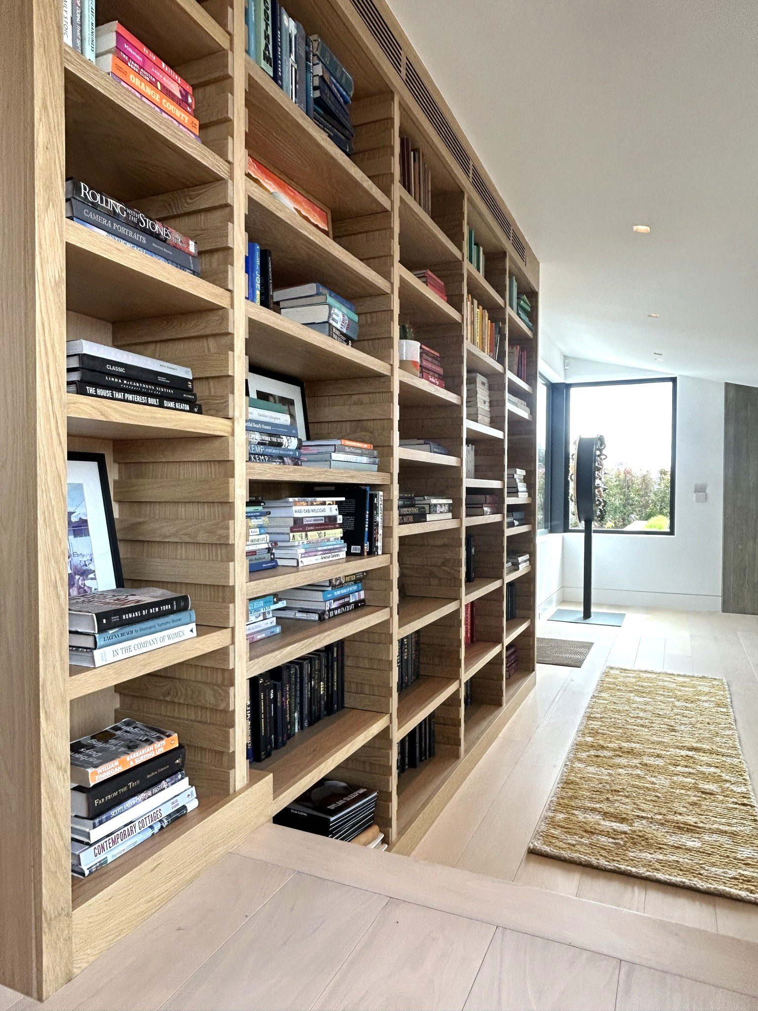 Custom white oak floor-to-ceiling bookcase full view library