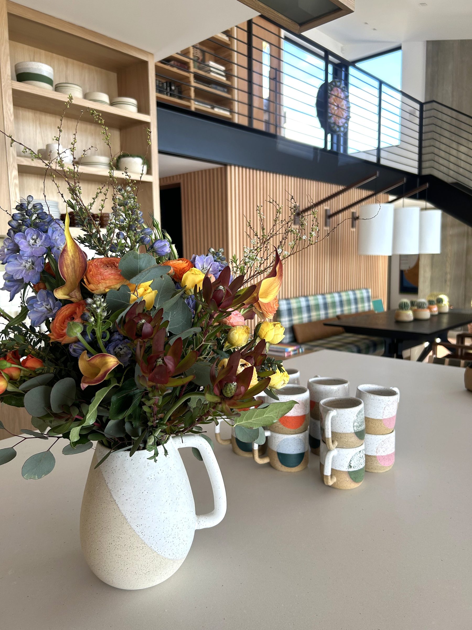 Modern white oak kitchen counter floral arrangement detail